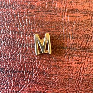 Keep collective gold letter M
